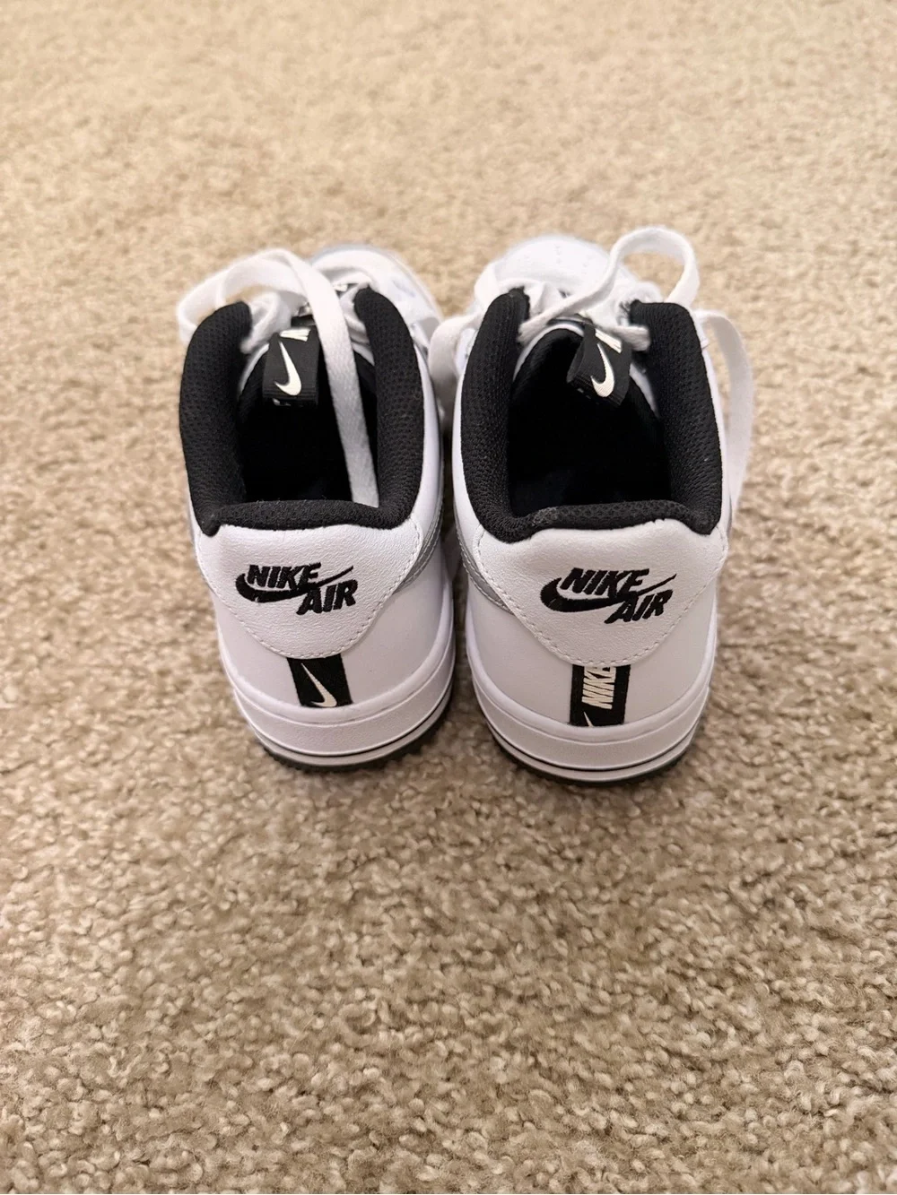 Nike Kids White and Black Low-Top Sneakers with Silver Swoosh